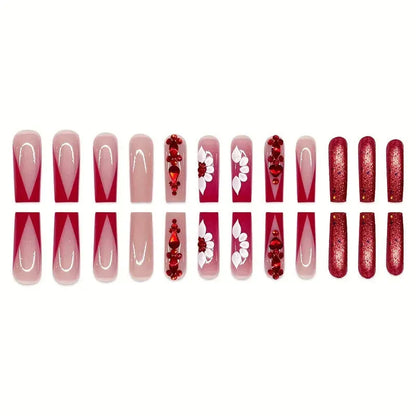 Sweet floral pattern press-on nails with red diamond accents in a long European Square shape.