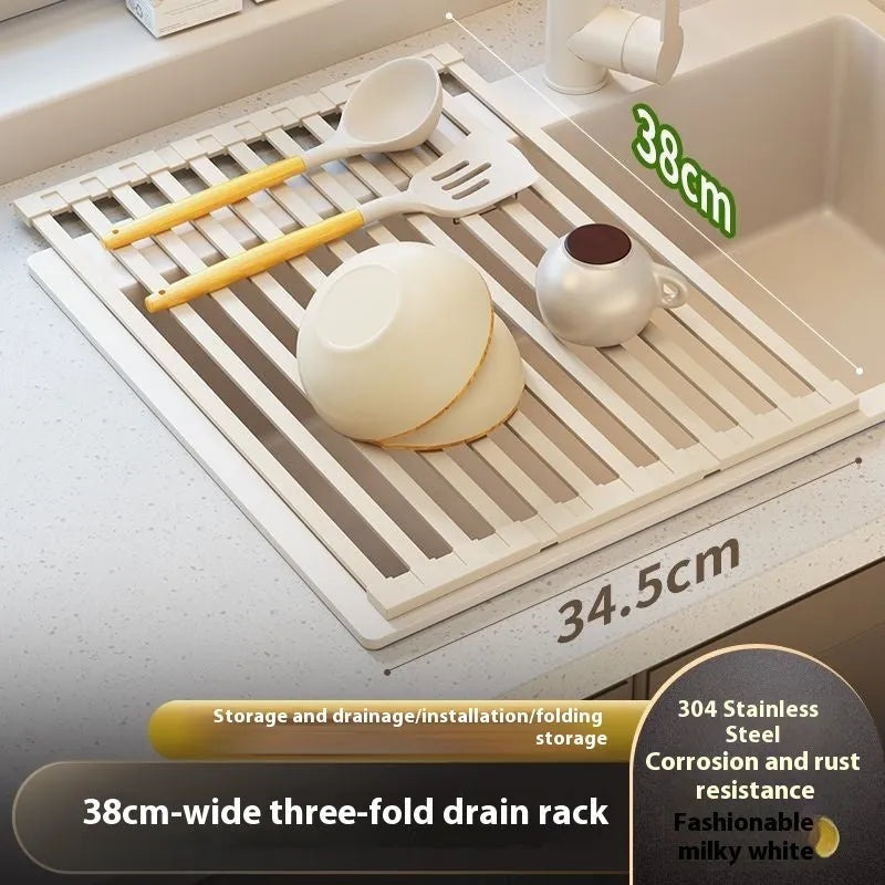 A milky white foldable stainless steel kitchen draining rack collapsed flat beside a kitchen sink.