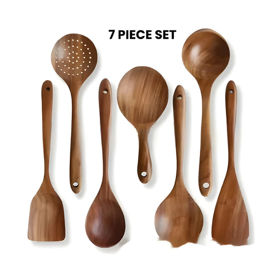 7-piece wooden kitchen utensil set with spoon, spatula, and soup spoon on a table
