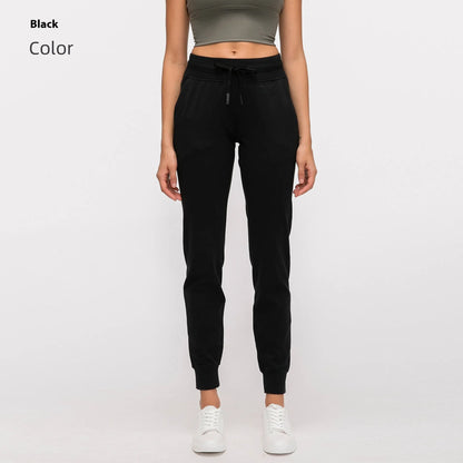 Women's high waist yoga pants with drawstring waistband in Belgian blue colour, showing stretch fabric during yoga pose