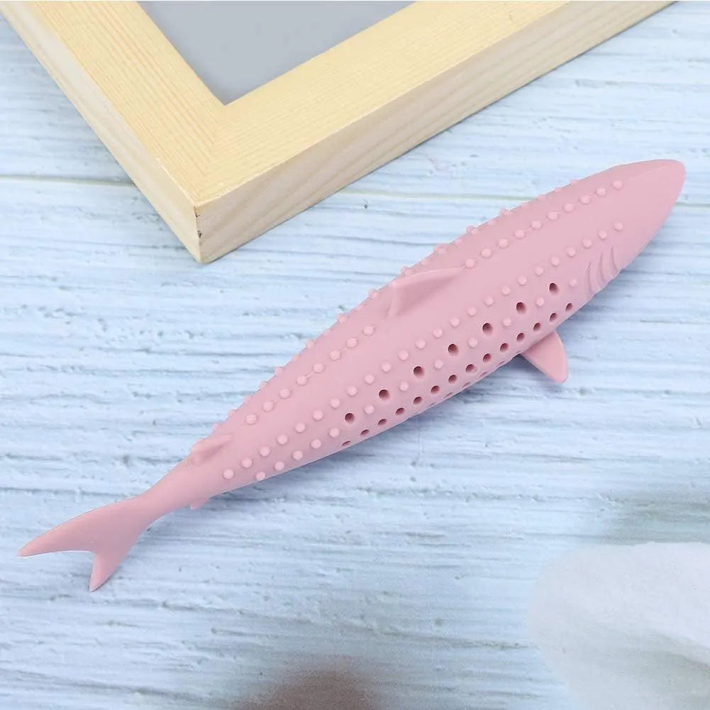 Green fish-shaped silicone cat chew toy with side holes, shown disassembled to reveal hollow interior for catnip.