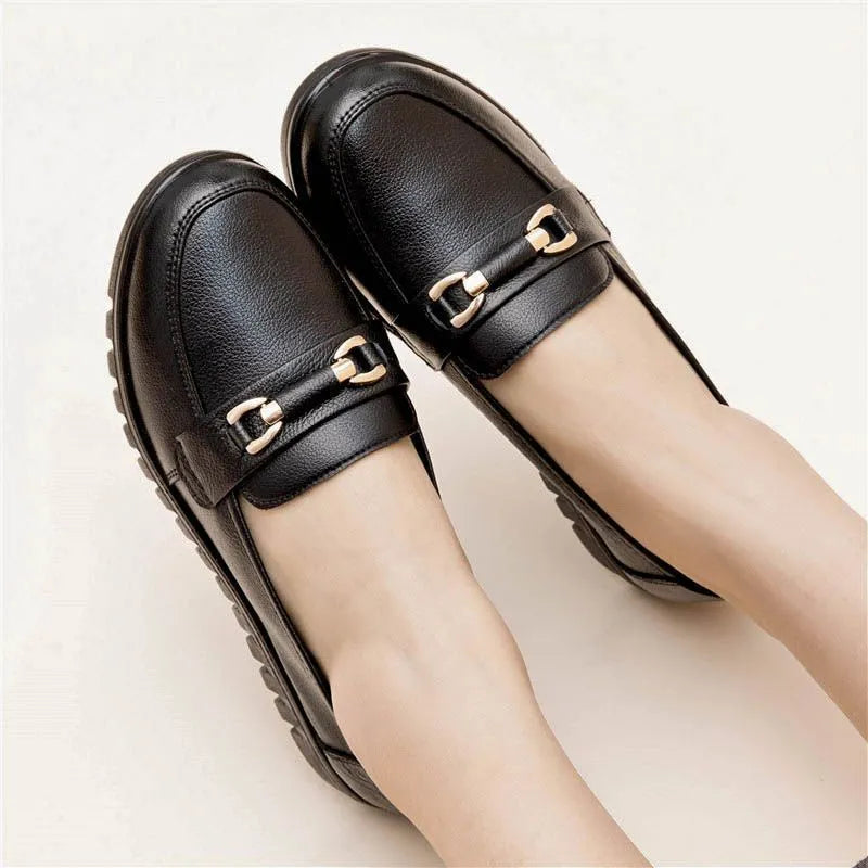 Black women's casual leather pumps with a round toe, low flat heel, and soft rubber sole.