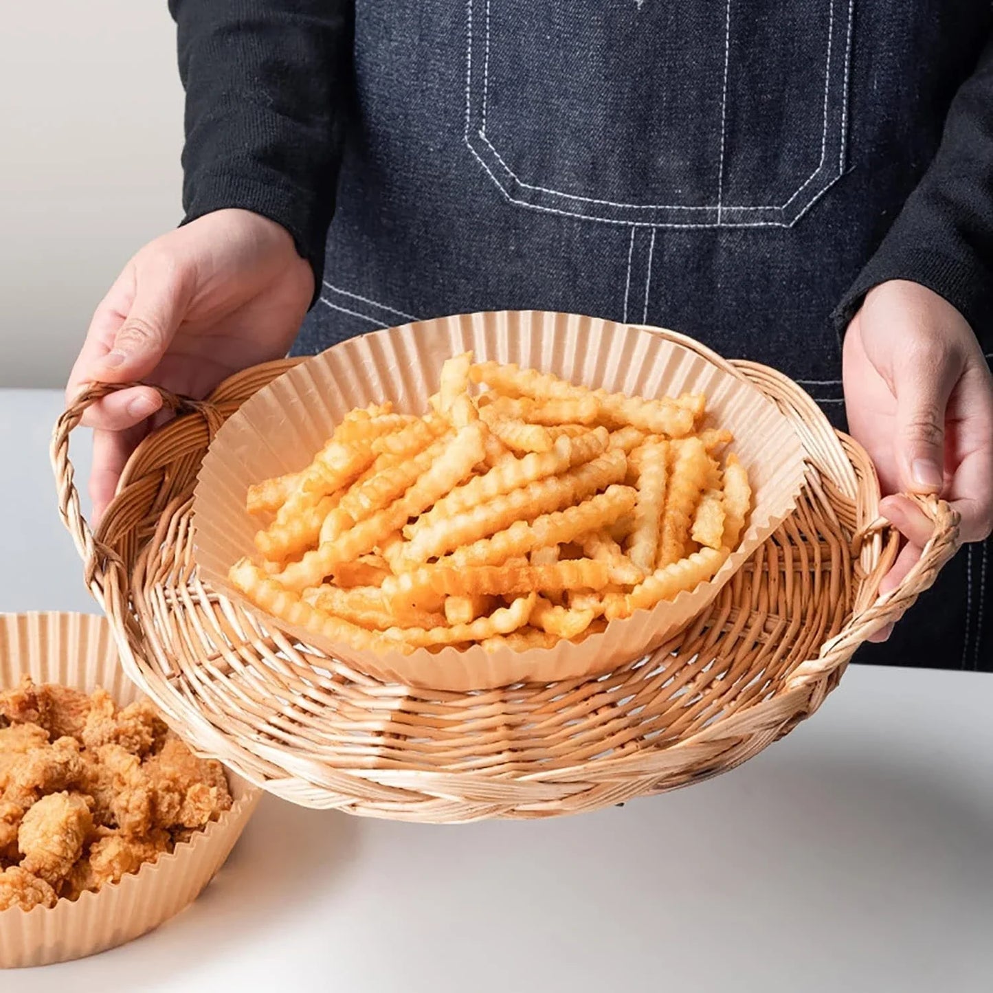 Disposable air fryer liners made of durable, food-grade parchment paper for effortless cleanup and healthy cooking