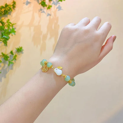 Chinese style glass bead bracelet with bamboo joint design on wrist.