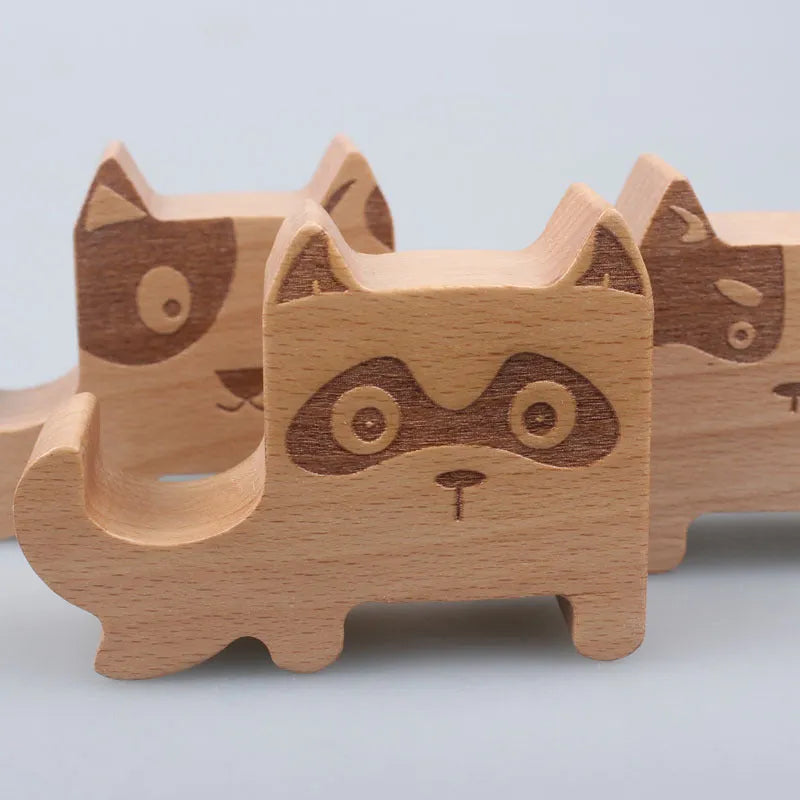 Beech wood mobile phone holder with coin slot showing adjustable angle and resin decorative elements