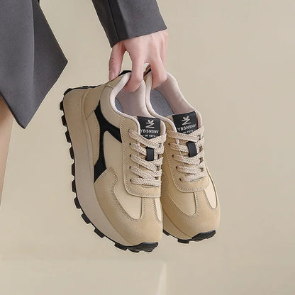 Women's solid colour low-top sports shoes with flat platform sole and lace-up front.