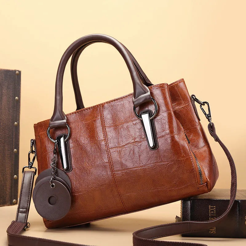 Large capacity bag with retro contrasting colour design, horizontal square PU leather shape with single shoulder strap and multiple internal compartments including zippered pockets for daily urban use