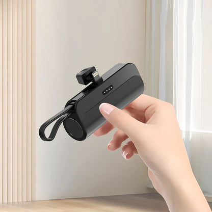 White capsule power bank showing compact 79mm size with USB charging ports visible