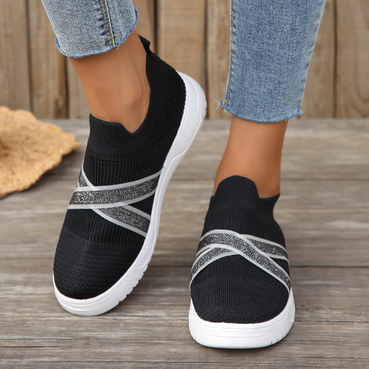 Black women's flyknit mesh flat shoes with rubber sole and tassel detail