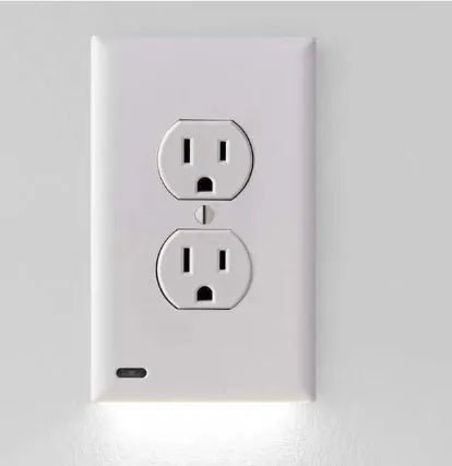White socket induction LED night light plugged into UK wall socket with automatic sensor