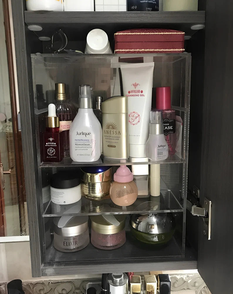 Clear acrylic cosmetic storage box measuring 24x10x34cm with transparent sides showing makeup organisation