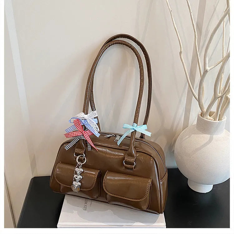 Retro brown PU leather women's pillow bag with a double shoulder strap and flap closure.