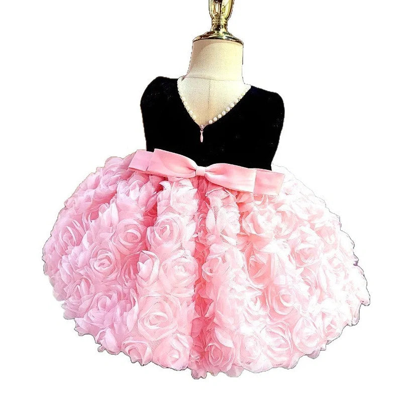 Pink girls summer dress with colour-matched design on hanger, showing polyester fabric texture