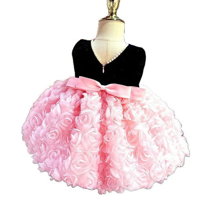 Pink girls summer dress with colour-matched design on hanger, showing polyester fabric texture