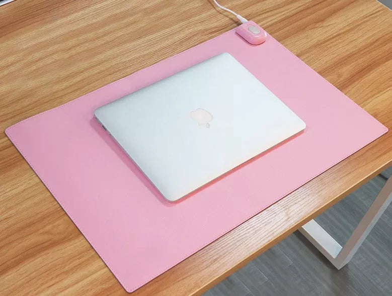 Two-stage Heating Desk Pad in black or pink, featuring quick warmth and waterproof design