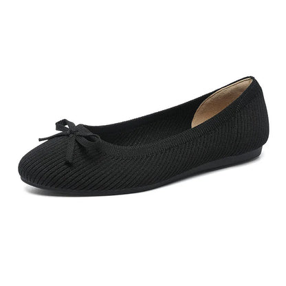 Women's black fabric flat pumps with a bow detail on the round toe, shown on a white background.