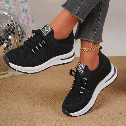 Women's black mesh lace-up platform sneakers with a round toe and flat rubber sole on a white background.