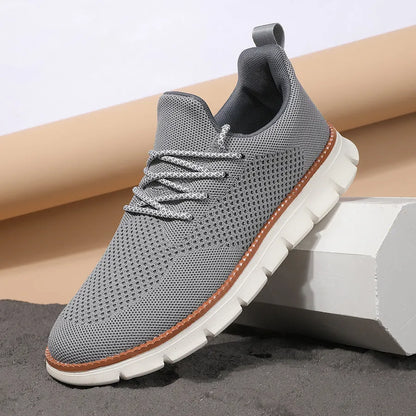 Men's grey and black low-top casual sneakers with a breathable mesh fabric upper.