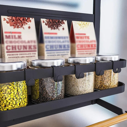 Black magnetic shelf mounted on refrigerator with spices and condiments organised neatly
