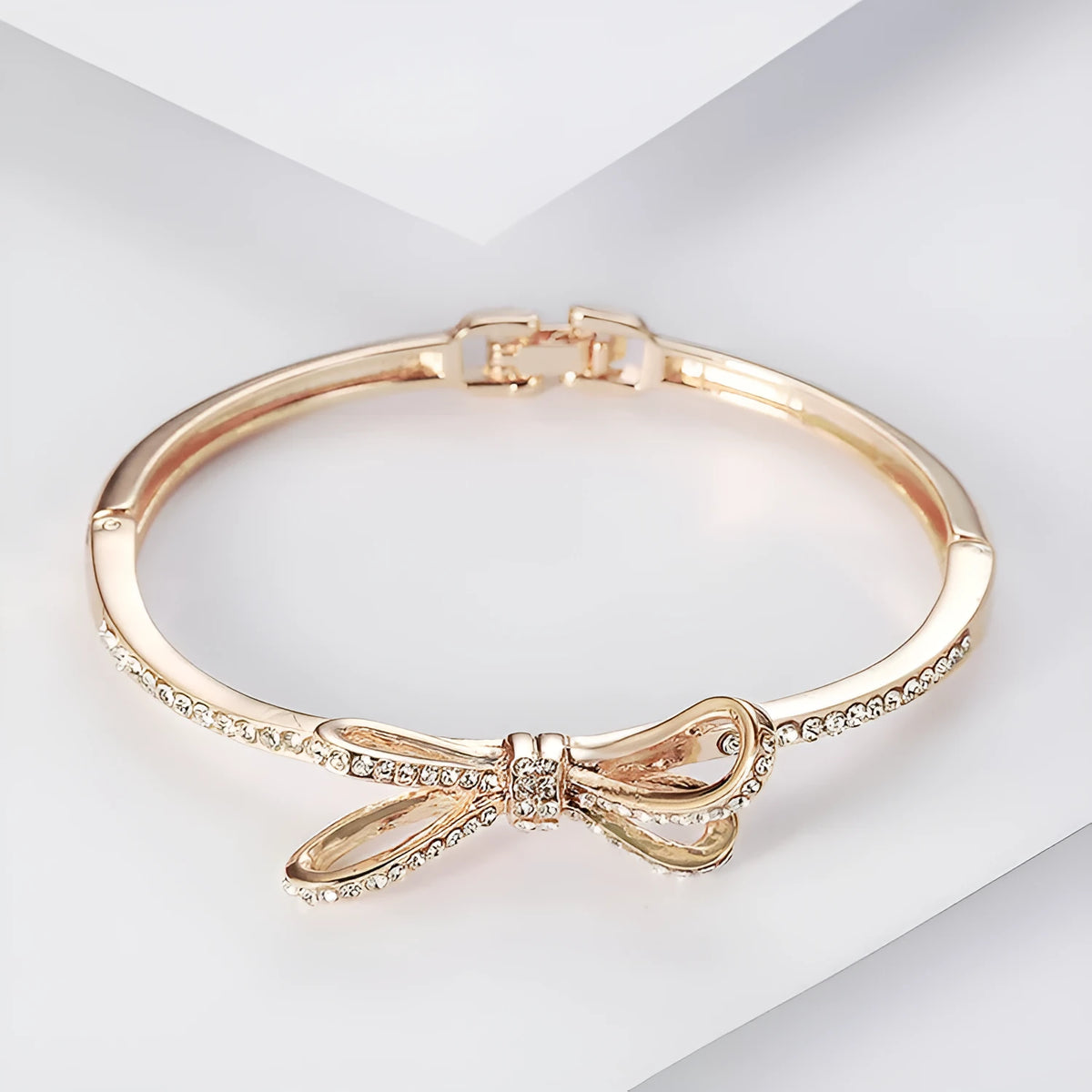 Women's rose gold alloy bracelet with bow design, diamond accent, and electroplated copper finish