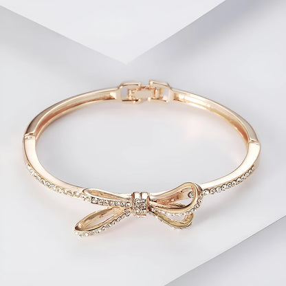 Women's rose gold alloy bracelet with bow design, diamond accent, and electroplated copper finish