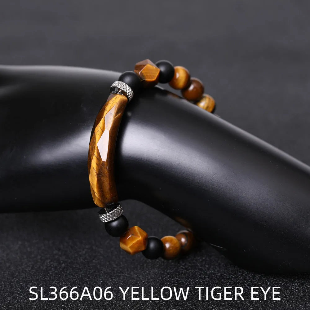 Handmade diamond-shaped cut black agate bracelet with fan-shaped details on a wrist.
