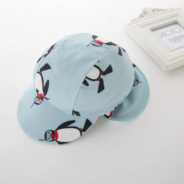 Boy's penguin print long sleeve swimsuit with matching cap for sun protection during water activities