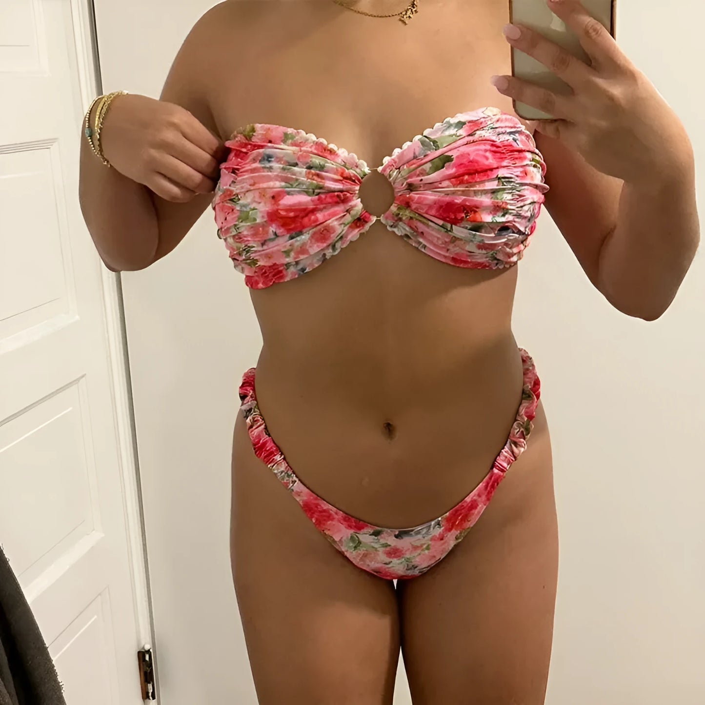 Colourful floral print tube top bikini set with lace trim on a mannequin