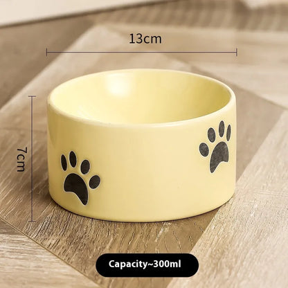 Ceramic cat bowl with high foot and cat's paw base in an oblique mouth design.