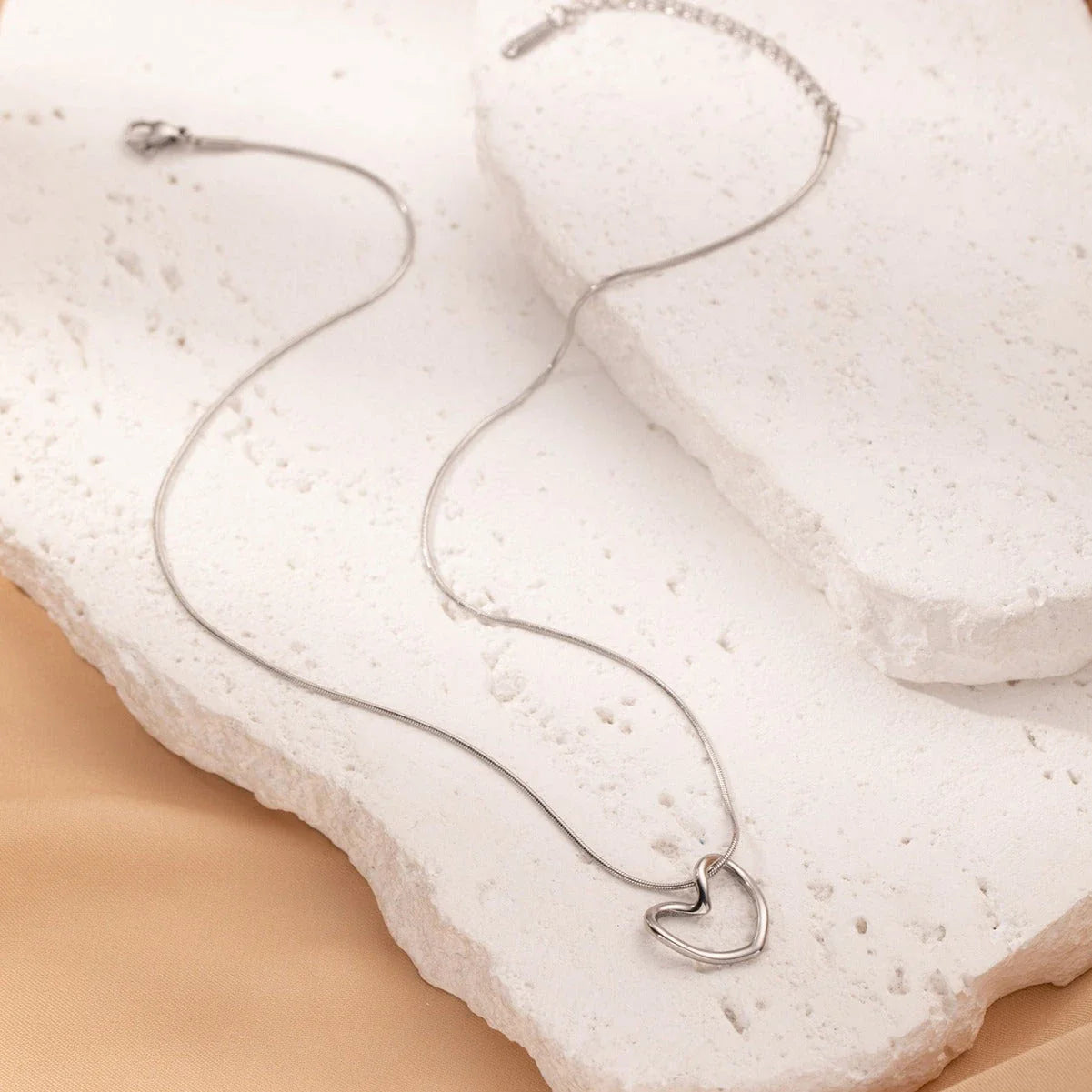 Stylish titanium steel heart pendant necklace with unique twist design, available in gold and silver colors