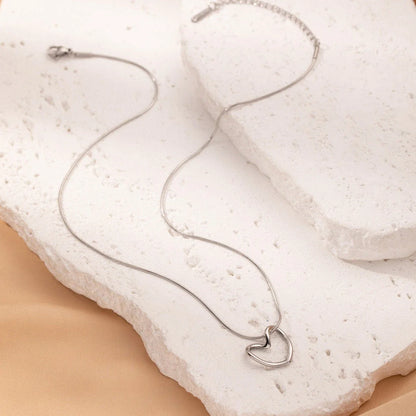 Stylish titanium steel heart pendant necklace with unique twist design, available in gold and silver colors
