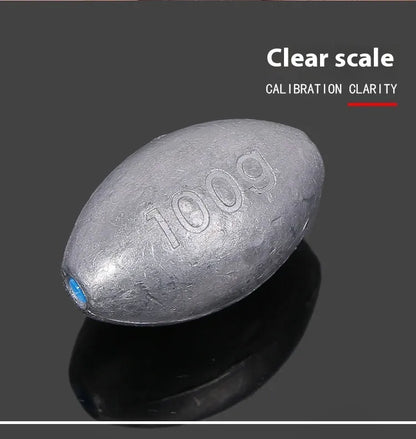 Rugby-shaped lead fishing sinker with scaled texture and plastic core protection for sea fishing