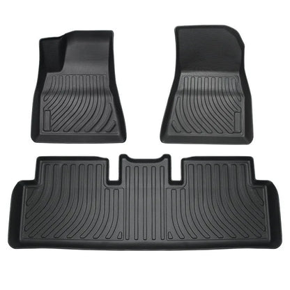 Black TPE rubber floor mats for Tesla Model 3, showing deep grooves and raised edges on driver's side.