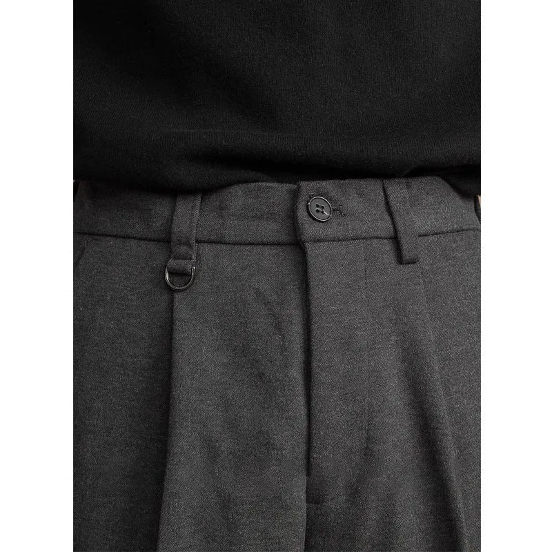 Man wearing straight cut draped polyester casual trousers in dark grey