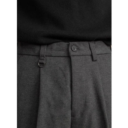 Man wearing straight cut draped polyester casual trousers in dark grey