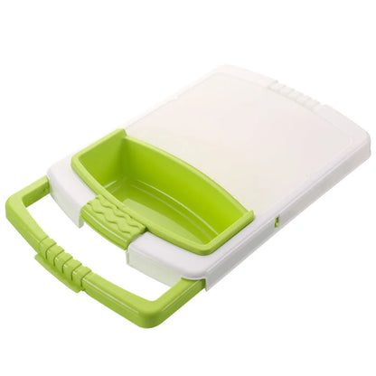 Green multifunction cutting board with drainage holes and storage trough mounted on a kitchen sink.