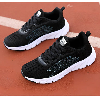 Women's black running sneakers with MD soles and cross strap detailing for jogging