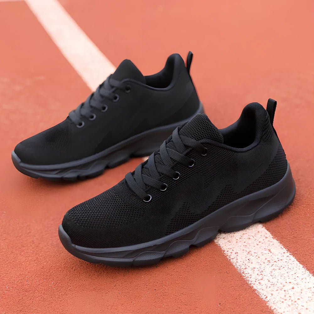 Women's black sneakers with mesh upper, wedge heel, and lace-up front