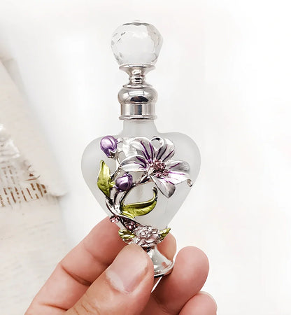 Heart-shaped refillable perfume bottle with metal and crystal construction, 3.6 inches tall
