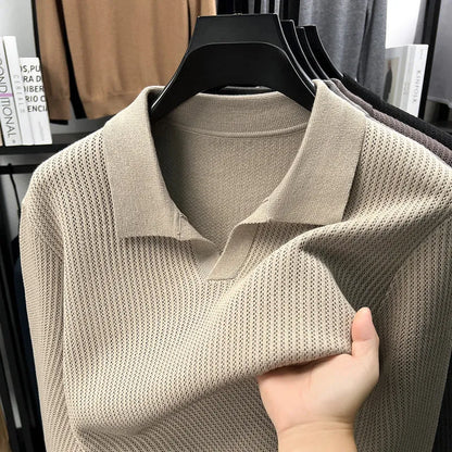 Man wearing a loose fit camel coloured pullover sweater, a casual autumn layer with a simple design.