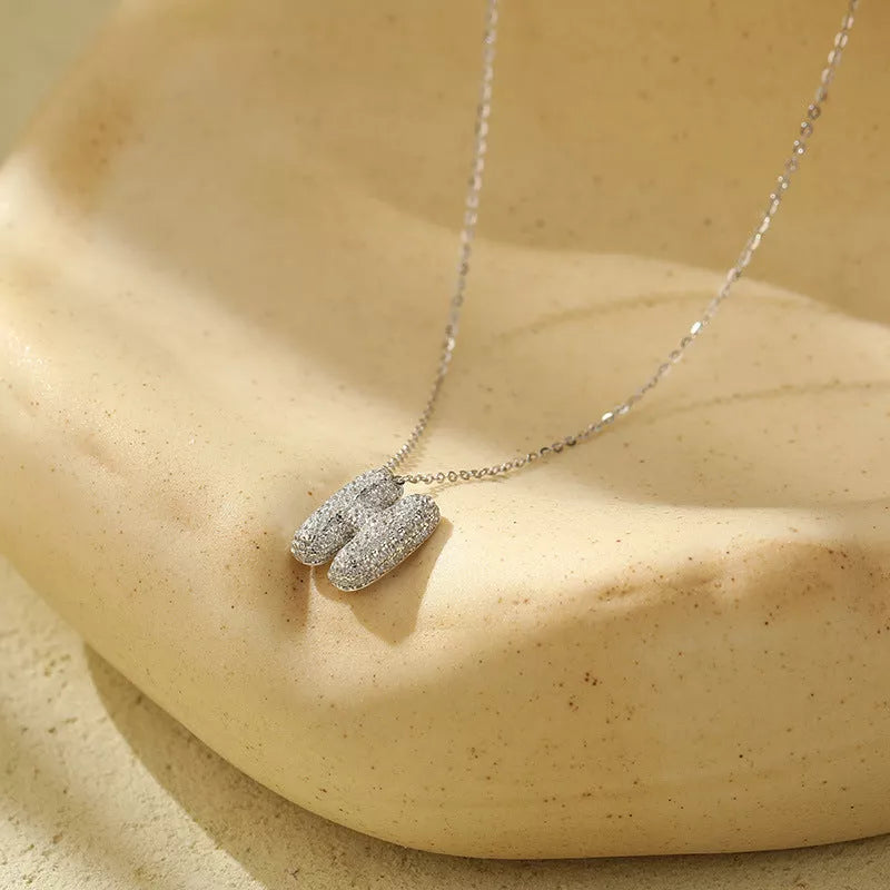 Stainless steel initial pendant necklace with zircon accents, personalized with your choice of letter.