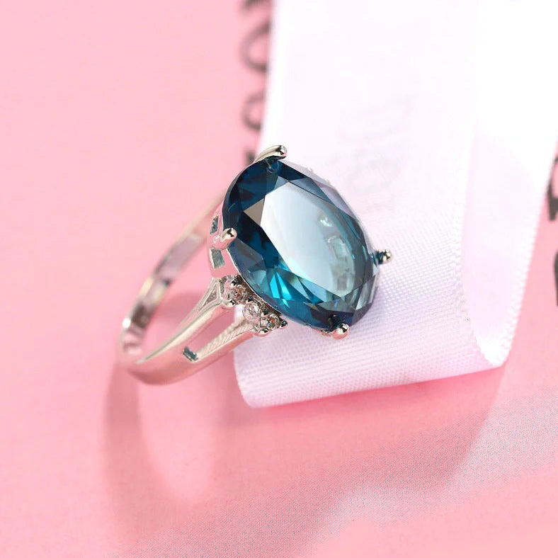 Geometric ellipse ring with electroplated blue black finish on copper, showing distinctive angles and curves