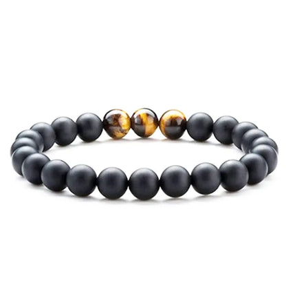 Tiger Eye and black agate geometric couple bracelets laid out as a matching set.