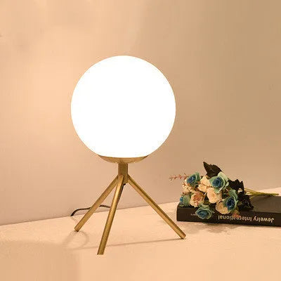 Creative glass table lamp with LED light in one of three available sizes for a living room or study
