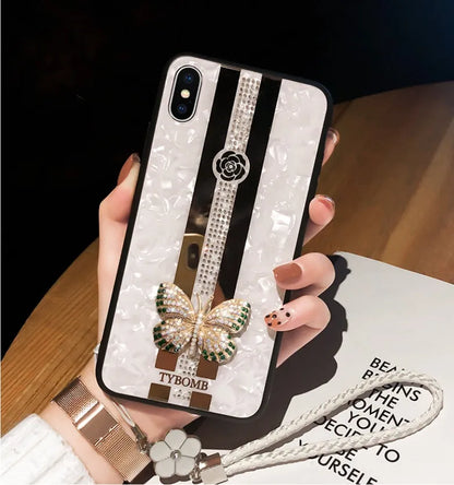 Clear acrylic iPhone case with Swarovski crystal butterfly design and central mirror in purple.
