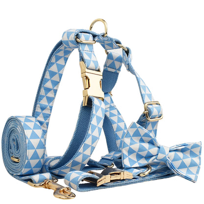 Blue cloth dog collar, leash, bow, and vest four-piece set with triangular metal ring, shown in a pet accessory bundle.