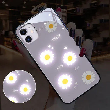 Luminous phone case with voice-activated colour lights showing painted daisy design on Apple iPhone