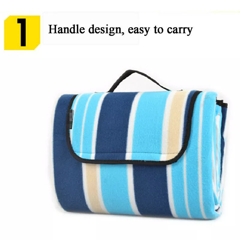 Folding Suede Picnic Moisture-proof Mat in blue stripes, unfolded on grass