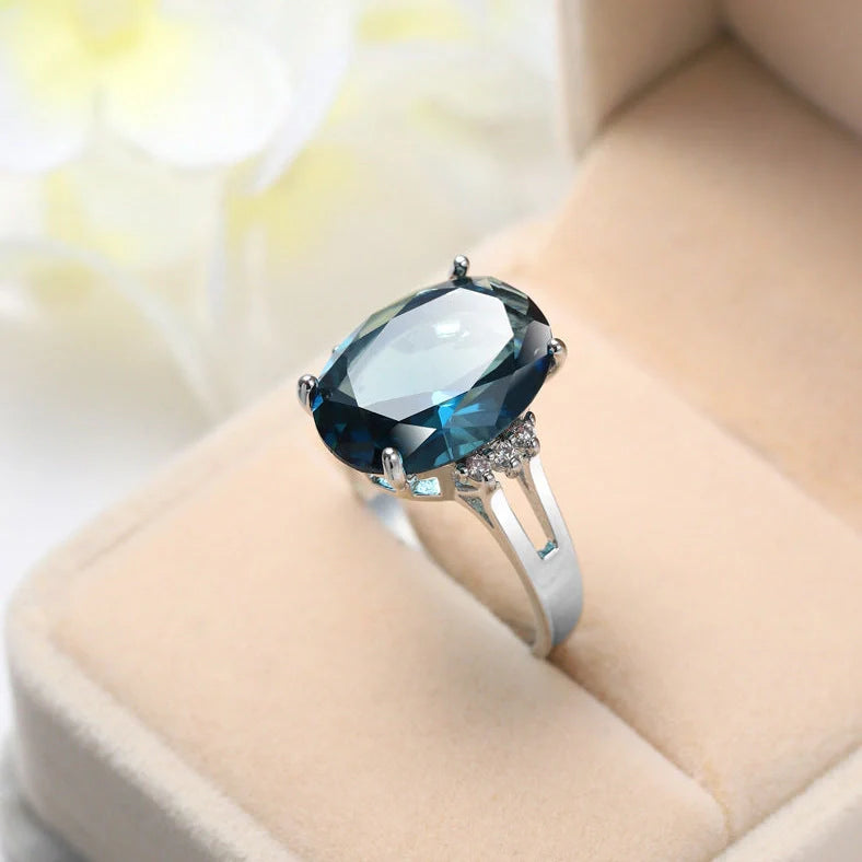 Geometric ellipse ring with electroplated blue black finish on copper, showing distinctive angles and curves