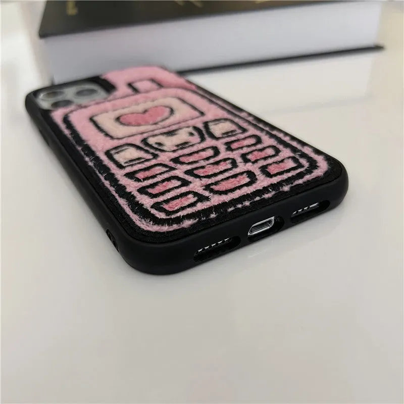 Pink soft TPU iPhone case with a towel-embroidered textured back for models iPhone X to 15.